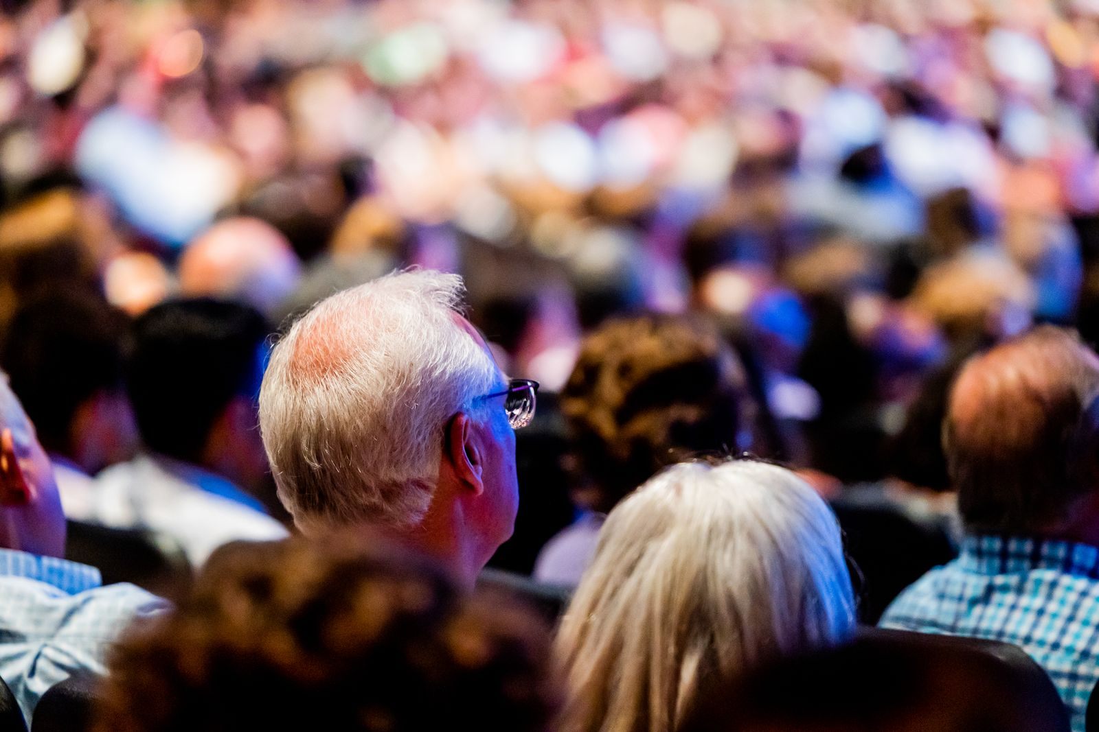 A large audience seated at a conference keynote, planning ahead for travel trade shows 2027